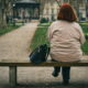 Usamljena žena sjedi na klupi u Zrinjevcu, Zagreb, Hrvatska.