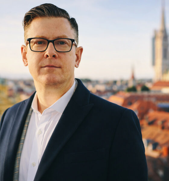 Odvjetnik pozira pred panoramom Zagreba.