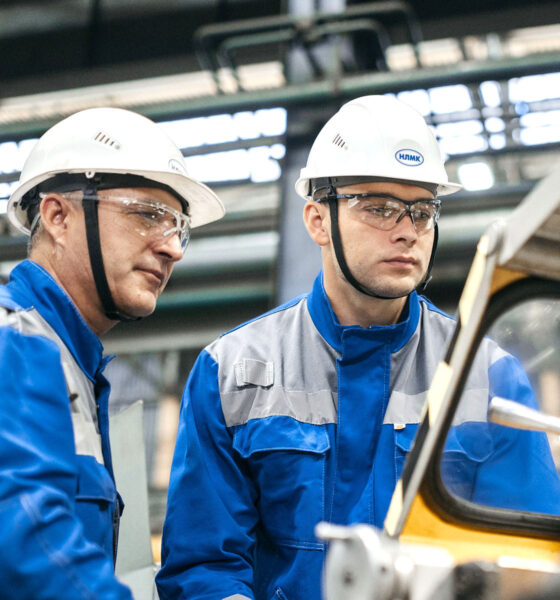 Dvojica radnika na proizvodnoj traci u tvornici automobila.