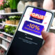 Kupac u trgovini Sinsay na mobitelu pregledava aktualne online popuste i ponude.